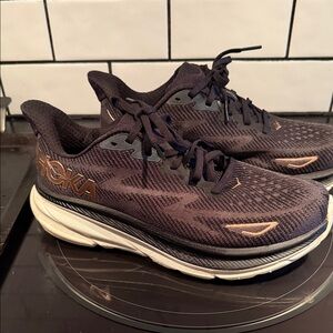 Hoka Black and Gold Athletic Shoes